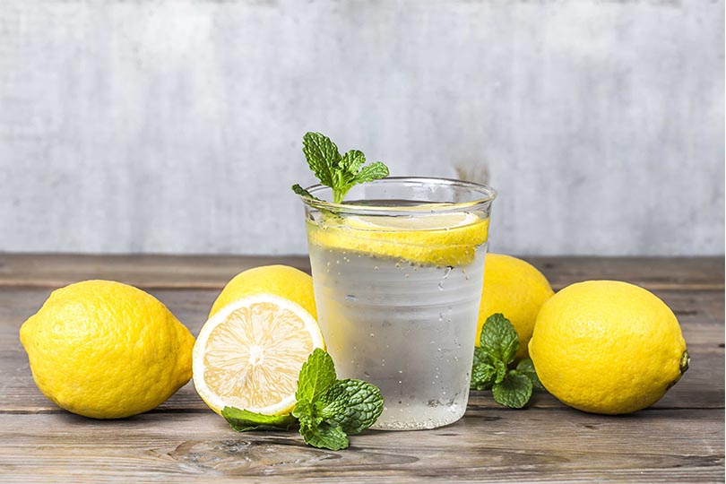a glass of hot water with lemon